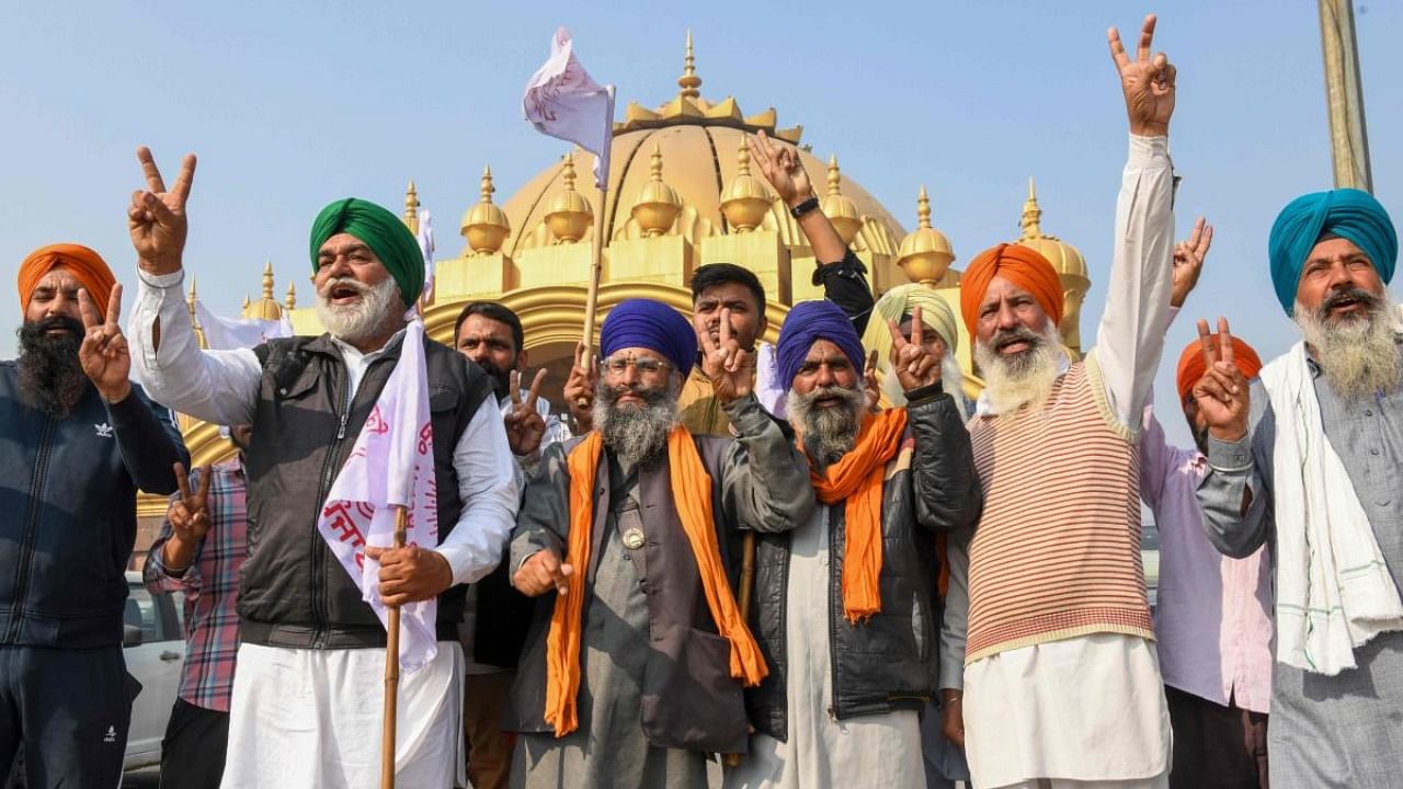 Farmers shout slogans to celebrate after Prime Minister announced to repeal three agricultural reform laws that sparked almost a year of huge protests across the country. Credit: AFP Photo