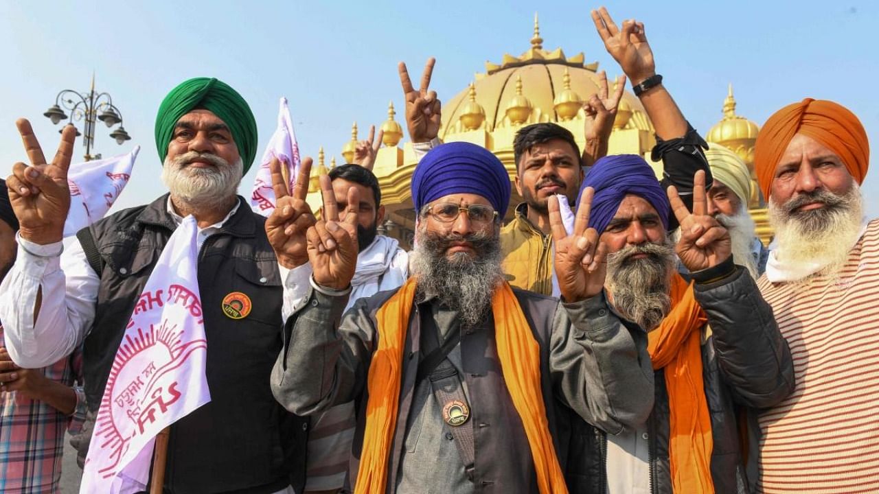 Farmers shout slogans to celebrate after Prime Minister announced to repeal three agricultural reform laws that sparked almost a year of huge protests across the country in Amritsar. Credit: AFP Photo