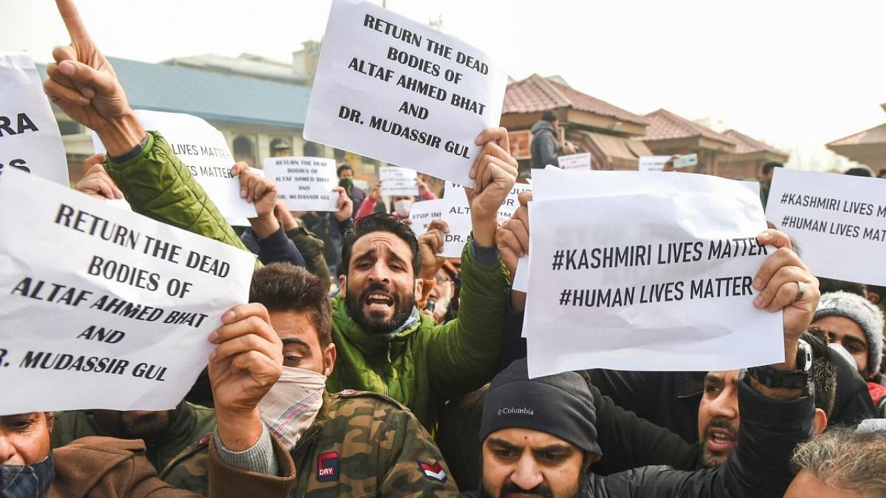 Leaders and workers of J&K People's Conference hold placards and shout slogans during a protest demanding a probe into the killings of civilians Altaf Ahmad Bhat & Mudasir Gul and the return of their bodies, in Srinagar, Thursday, Nov. 18, 2021. Credit: PTI Photo