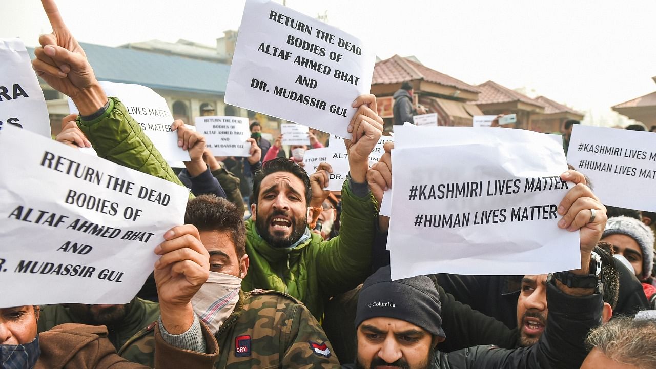  Leaders and workers of J&K People's Conference hold placards and shout slogans during a protest demanding a probe into the killings of civilians Altaf Ahmad Bhat & Mudasir Gul and the return of their bodies, in Srinagar. Credit: PTI Photo