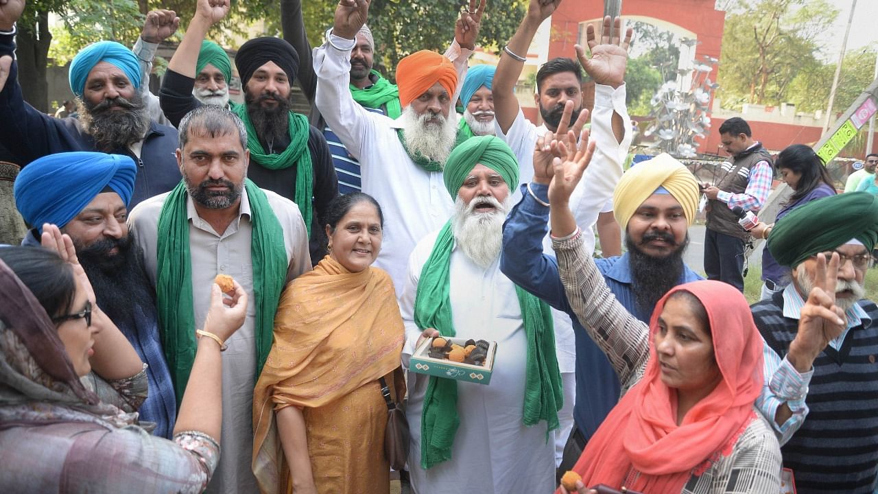  Farmers celebrate after Prime Minister Narendra Modi announced the repealing of the three Central farm laws, in Jalandhar. Credit: PTI Photo