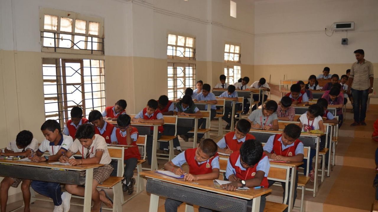 Students write an inter-school talent hunt exam in Hubballi recently. Credit: DH Photo