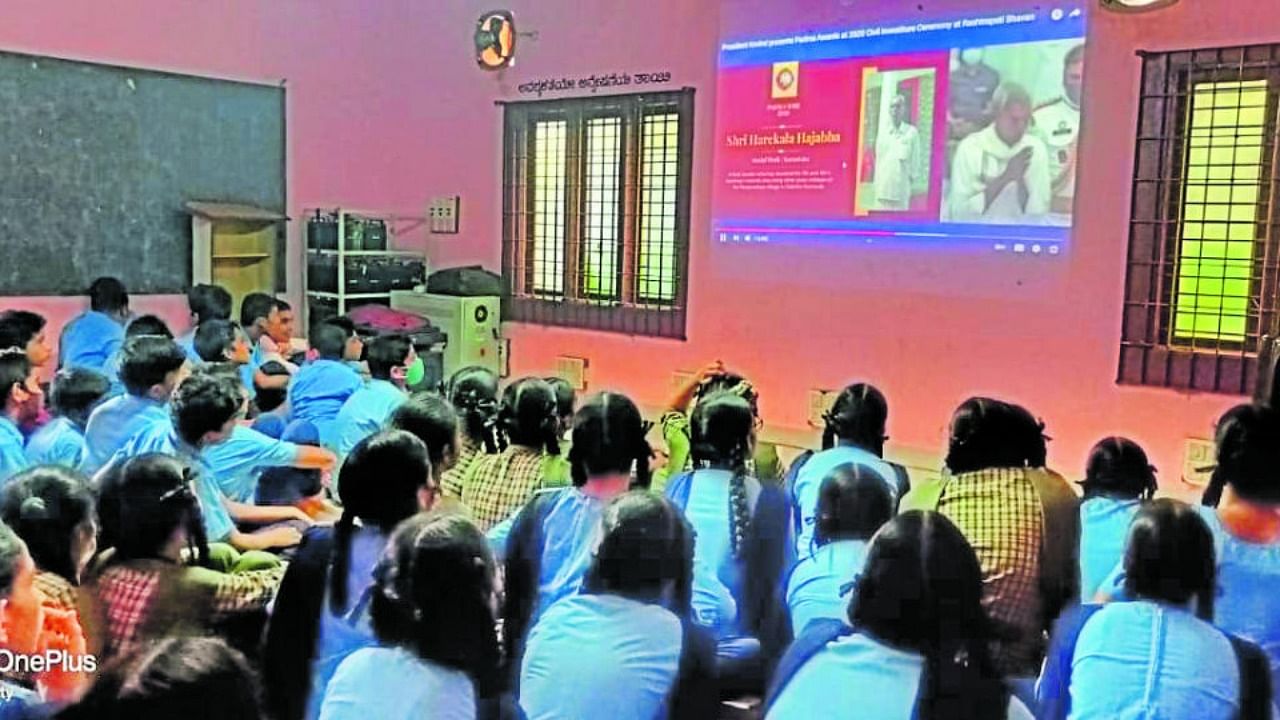 Eyes of students at `Hajabba' school in Newpadpu village, on outskirts of Mangaluru, were glued to the LED screen as Harekala Hajabba received the Padma Shri award from President of India Ram Nath Kovind in New Delhi on Monday. Credit: DH photo