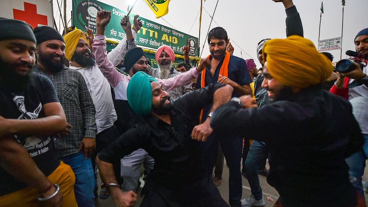 Farmers dance as they celebrate after Prime Minister Narendra Modi announced the repealing of the three Central farm laws, at Singhu Border in New Delhi. Credit: PTI File Photo