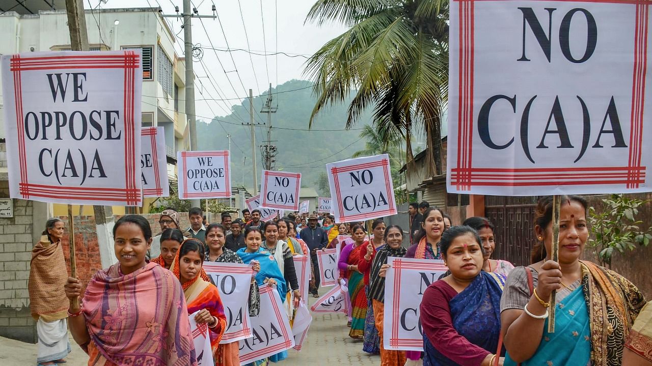 A file photo of women holding placards as they march during a demonstration against the Citizenship Amendment Act (CAA), in Guwahati. Credit: PTI File Photo