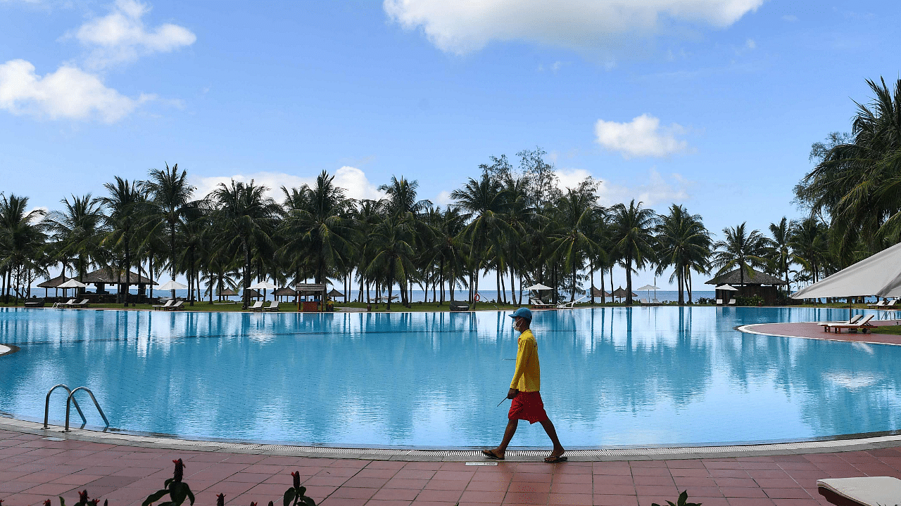 A staff member walks past a swimming pool inside the Vinpearl resort on Phu Quoc island. Credit: AFP Photo