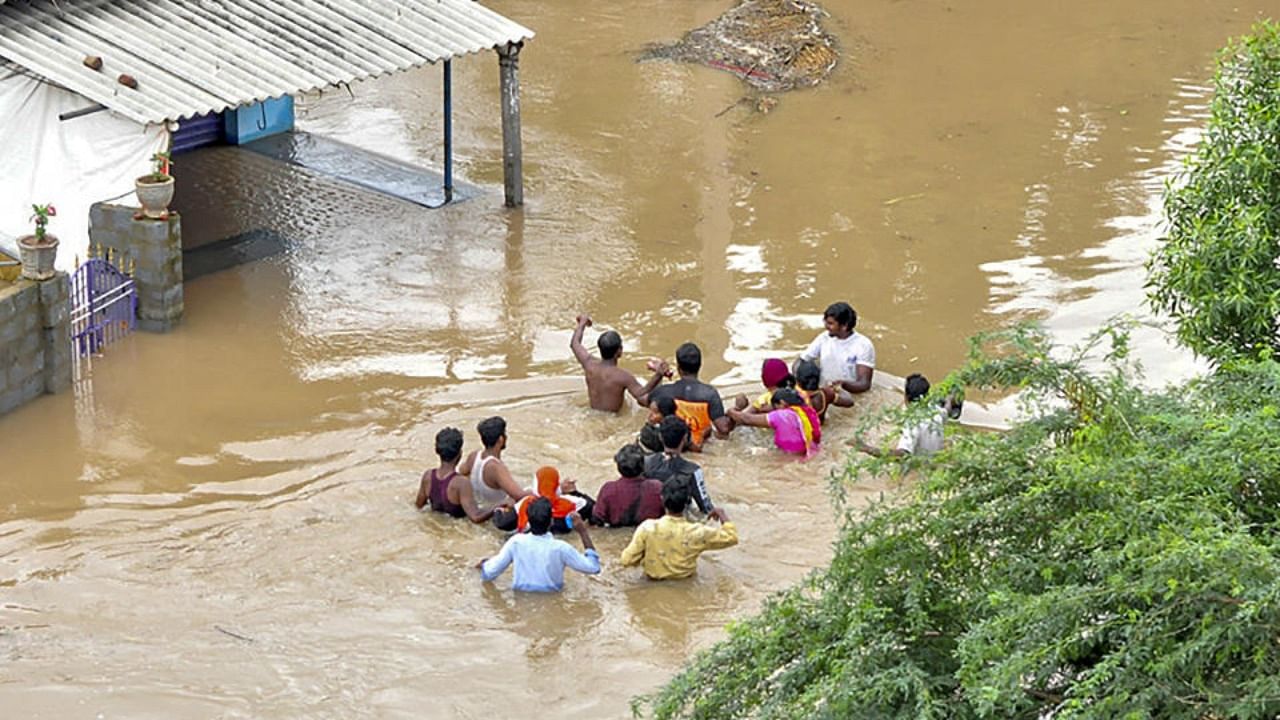 Residents wade through a flood-affected area in Nellore district of Andhra Pradesh, Saturday, Nov. 20, 2021. Credit: PTI Photo