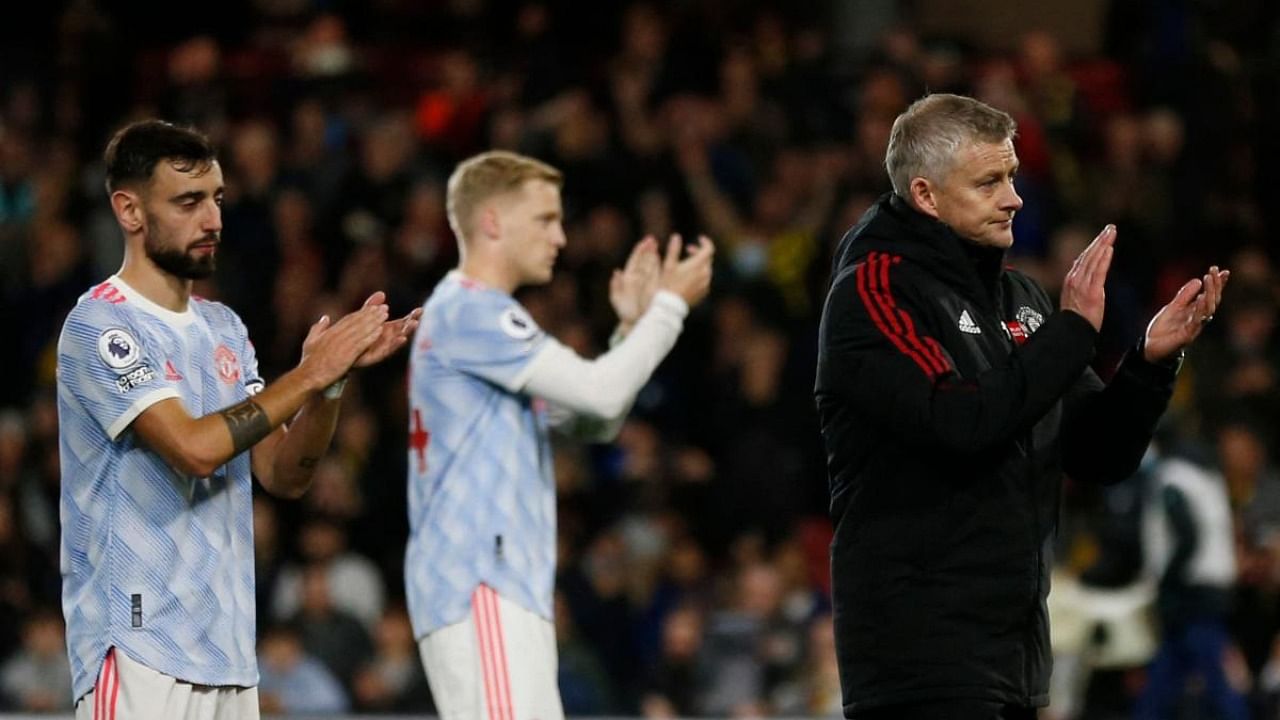 Manchester United's Norwegian manager Ole Gunnar Solskjaer and players react at the final whistle during the English Premier League football match between Watford and Manchester United at Vicarage Road Stadium in Watford. Credit: AFP Photo