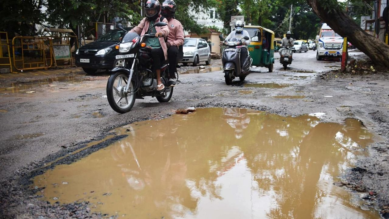 More frustrating for citizens and civic authorities would be the reemergence of potholes on recently repaired roads as rains washed away asphalt. Credit: DH Photo