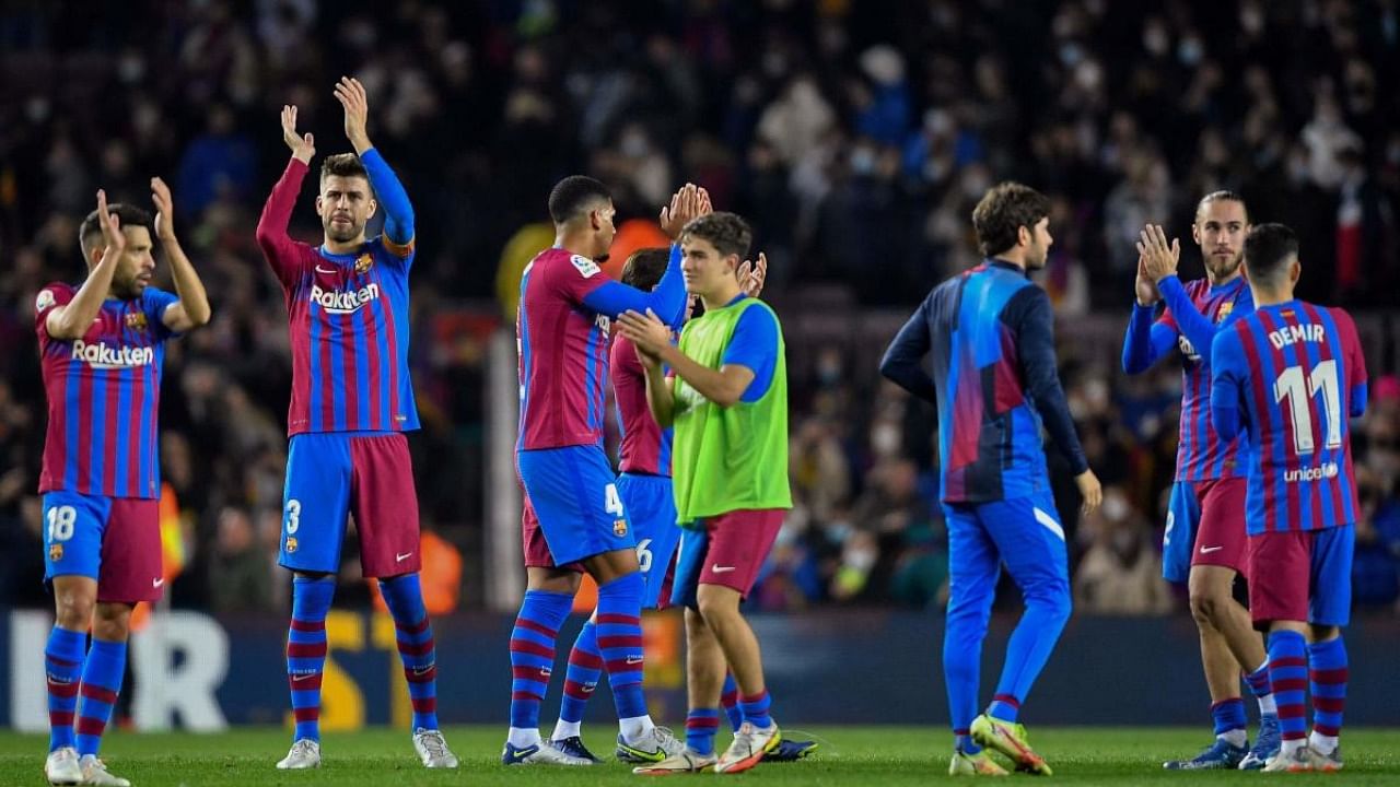 FC Barcelona's players celebrates at the end of the Spanish league football match between FC Barcelona and RCD Espanyol, at the Camp Nou stadium in Barcelona. Credit: AFP Photo