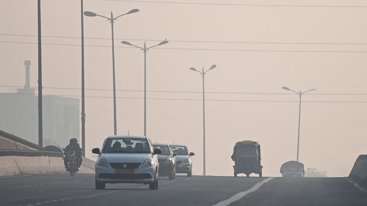 The air quality in the national capital was recorded under the 'very poor' category on Sunday, while shallow fog in some areas reduced visibility, affecting the traffic movement. Credit: AFP Photo