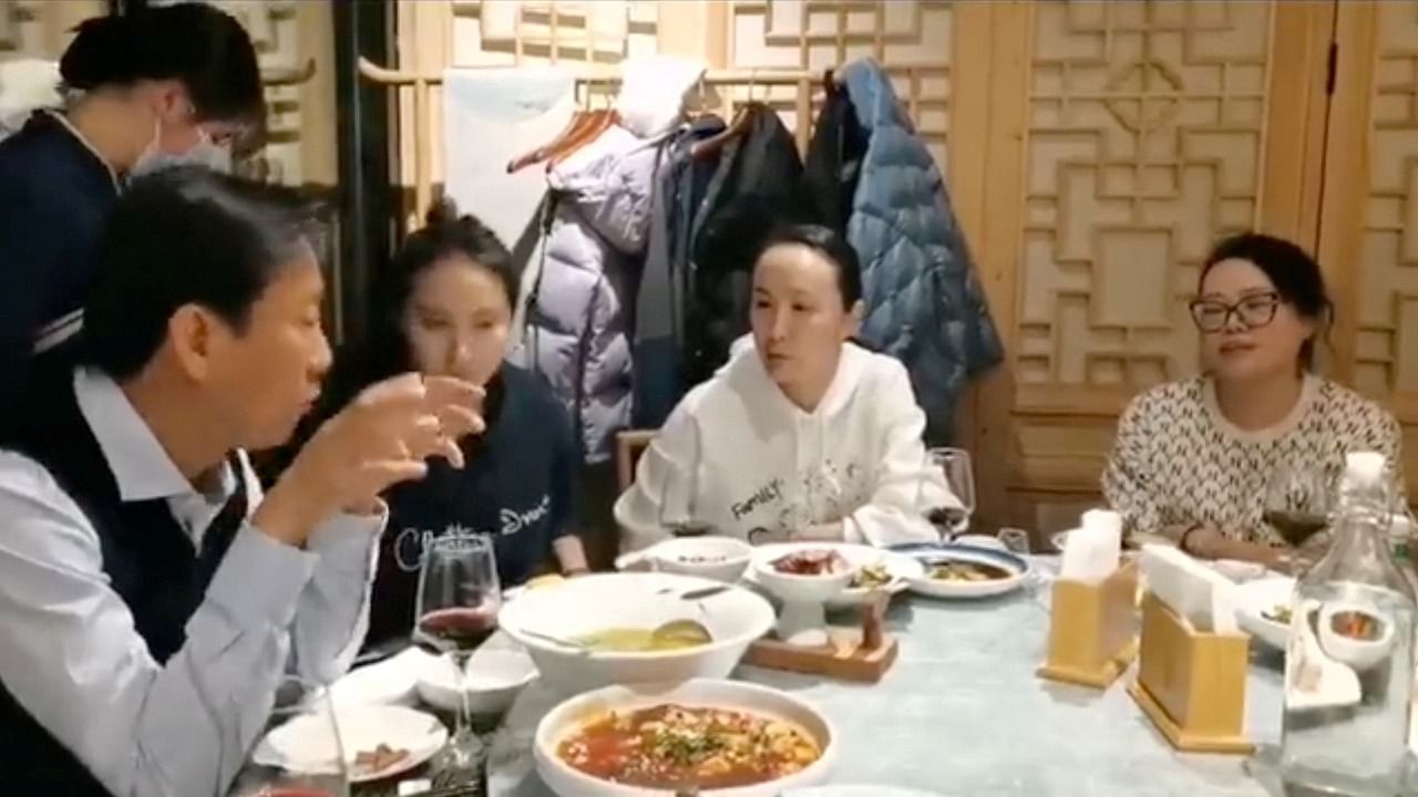 Peng Shuai is seen having dinner with her coach and friends at a restaurant in this still image from a social media video. Credit: Reuters Photo