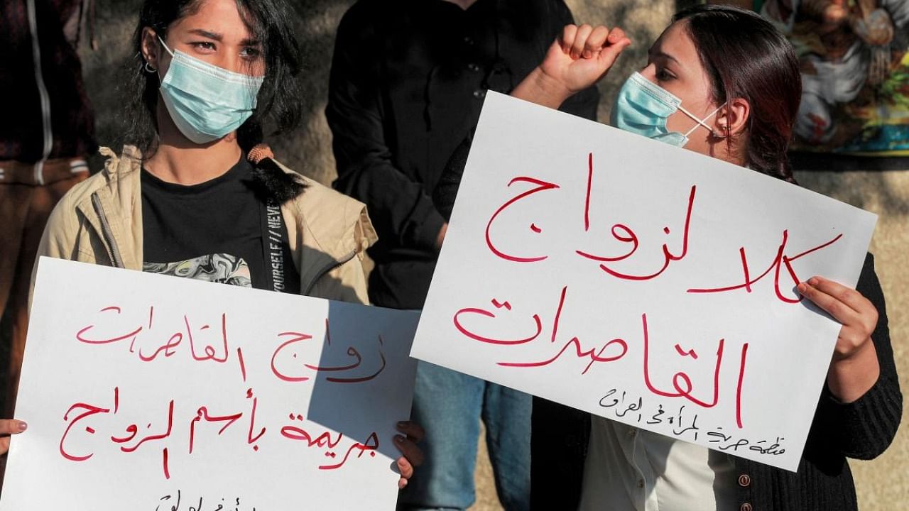 Women demonstrate near the Kadhimiya court in Iraq's capital Baghdad on November 21, 2021, in protest against the legalisation of a marriage contract for a 12-year-old girl. Credit: AFP Photo