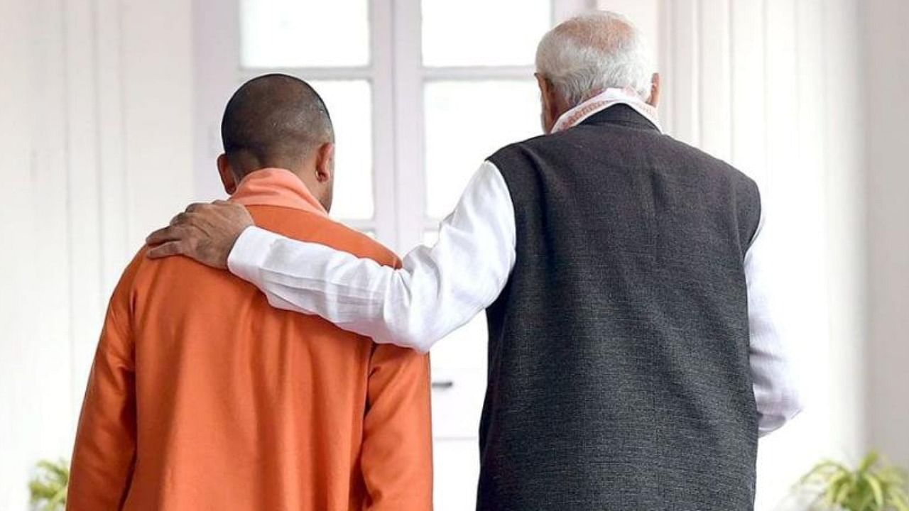 PM Narendra Modi (R) places a hand over the shoulder of Uttar Pradesh CM Yogi Adityanath. Credit: Twitter/@myogiadityanath