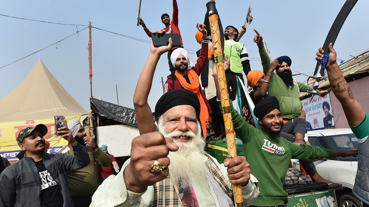 Farmers celebrate after Prime Minister Narendra Modi announced the repealing of the three Central farm laws, at Singhu Border. Credit: PTI Photo