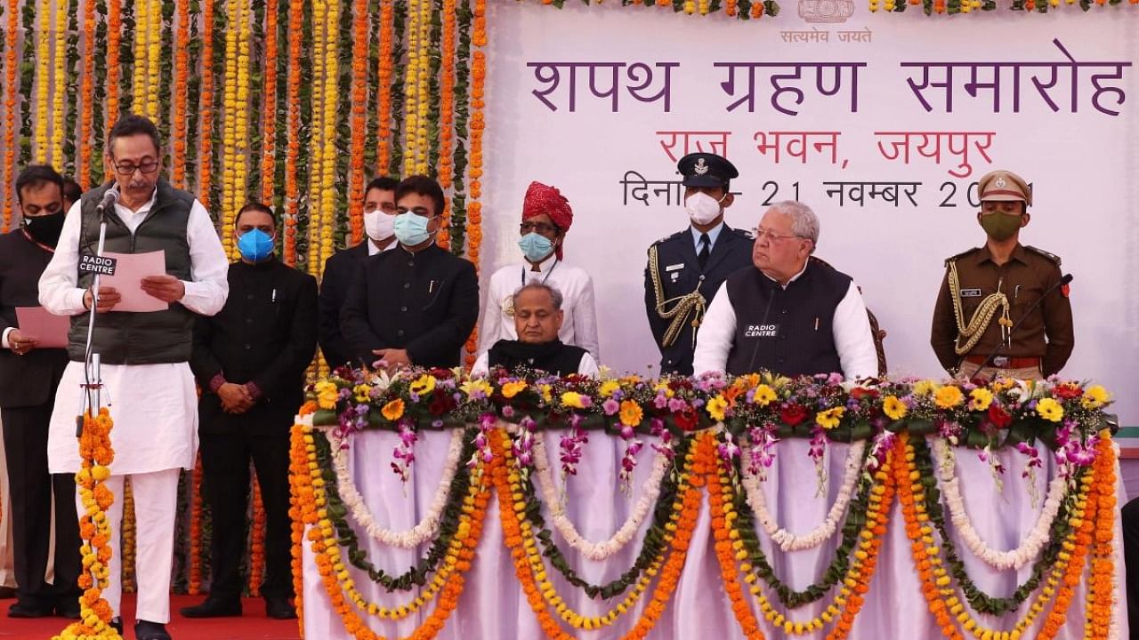 Congress MLA Vishvendra Singh Bairwa takes oath as Cabinet minister in the presence of Rajasthan Chief Minister Ashok Ghelot and Governor Kalraj Mishra during a swearing-in-ceremony, at Raj Bhawan in Jaipur. Credit: PTI Photo