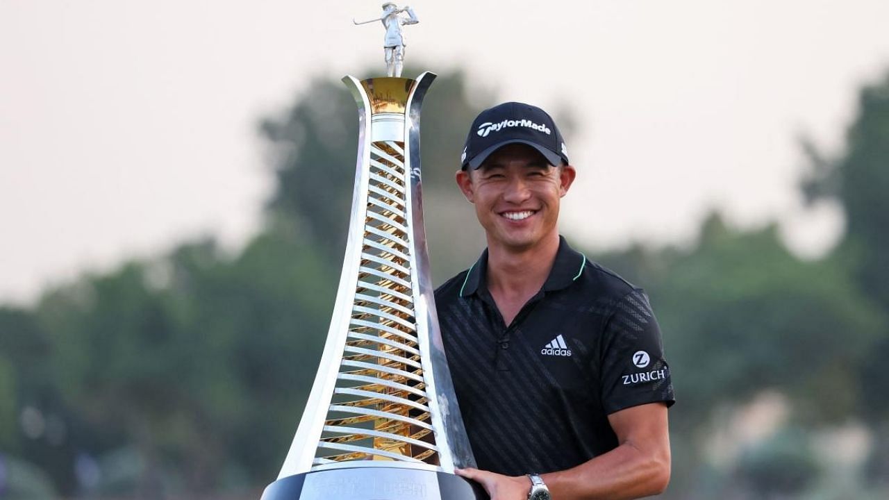 Collin Morikawa of the US poses with the winner's trophy during awards ceremony of the Dubai DP World Tour Championship. Credit: AFP Photo