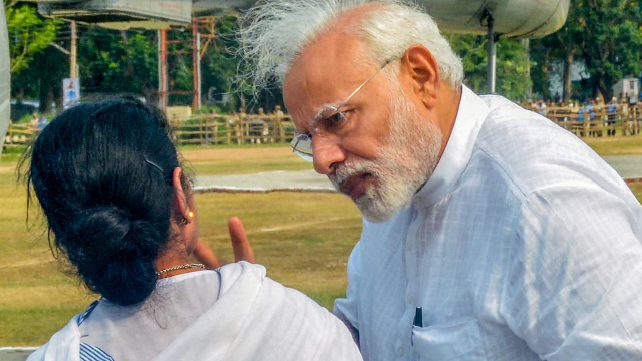 Prime Minister Narendra Modi talks to West Bengal Chief Minister Mamata Banerjee. Credit: PTI File Photo