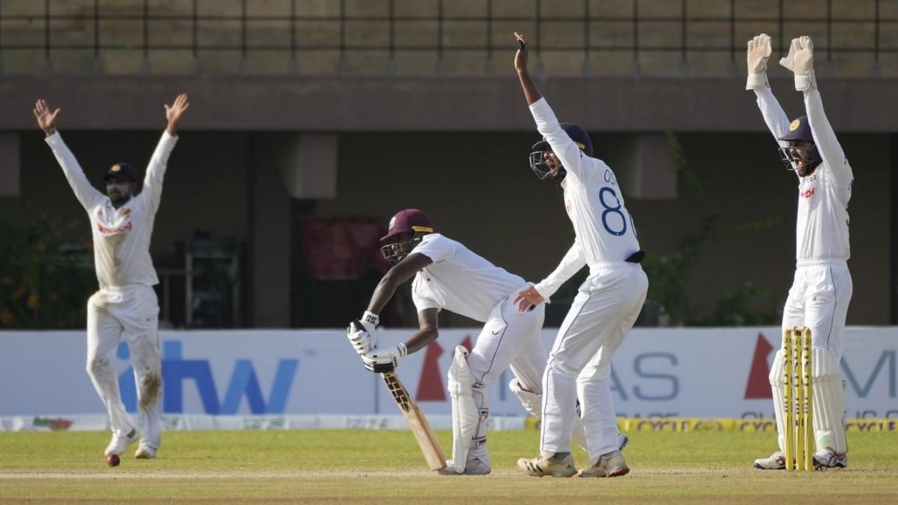 Members of the Sri Lankan team successfully appeals to dismiss West Indies' Jermaine Blackwood during the day two of their first Test cricket match. Credit: AP Photo