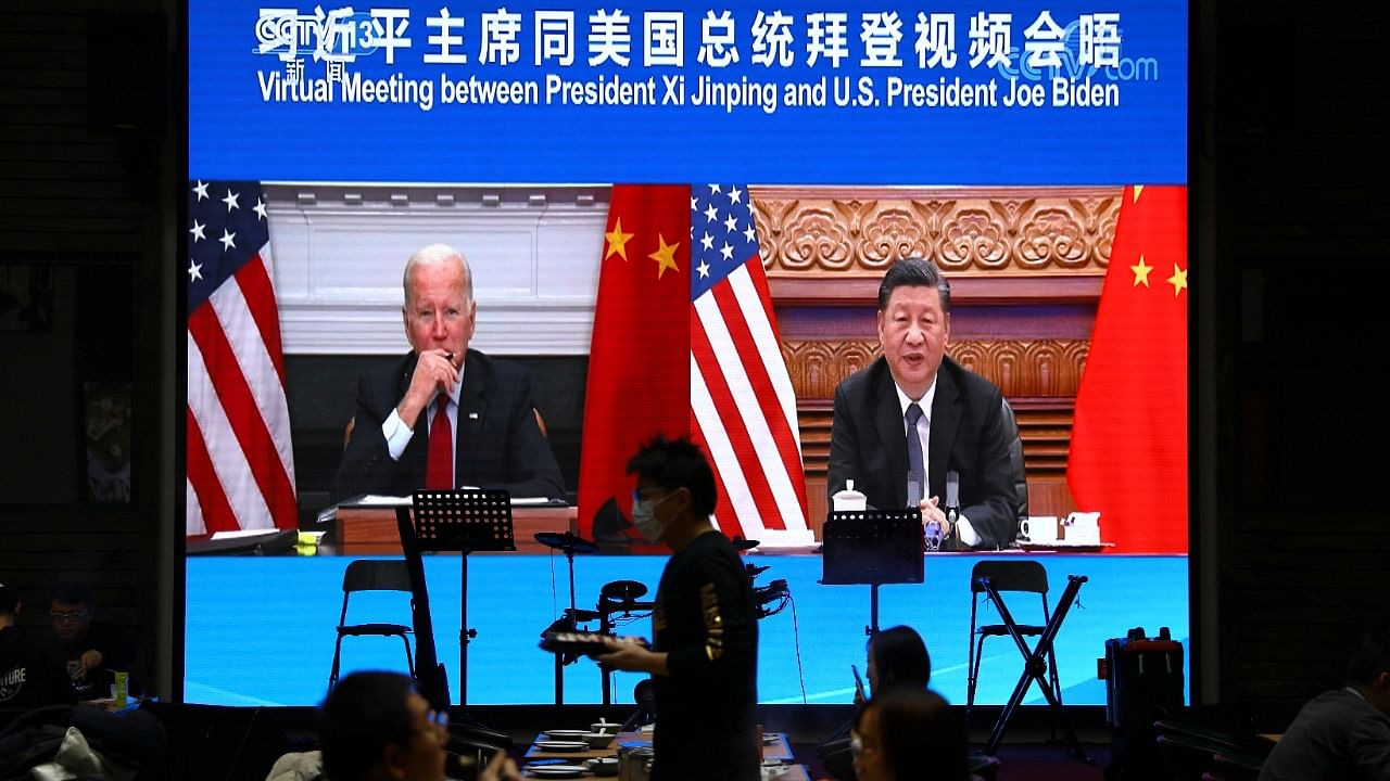 Screen shows Chinese President Xi Jinping attending a virtual meeting with US President Joe Biden via video link, at a restaurant in Beijing. Credit: Reuters File Photo