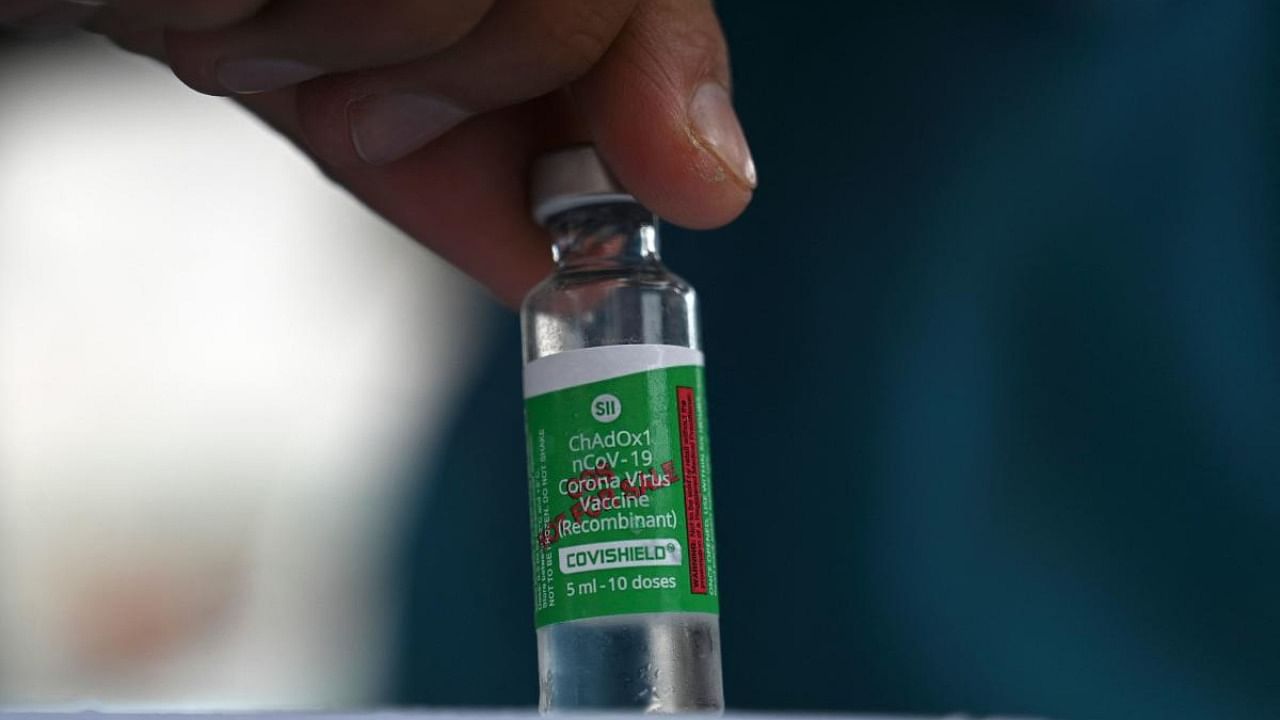A health worker shows a vial the Covishield AstraZeneca-Oxford's Covid-19 coronavirus vaccine. Credt: AFP Photo