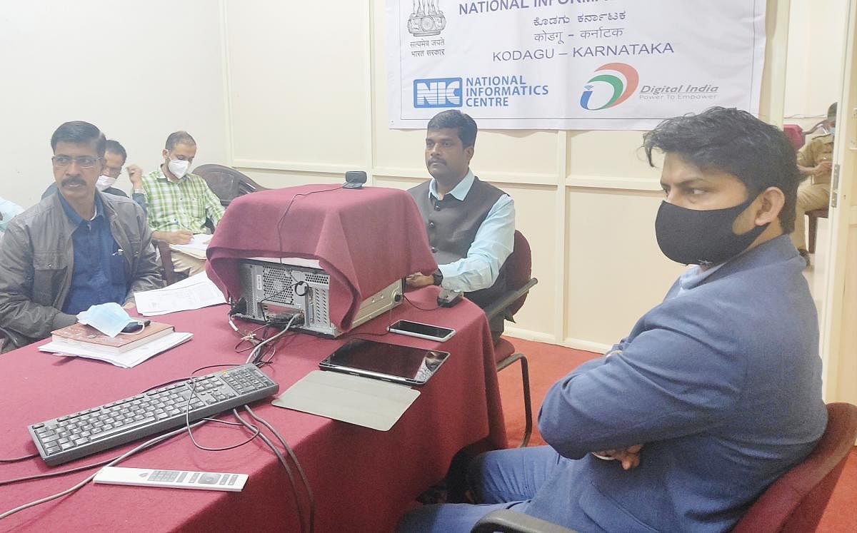 Deputy Commissioner Dr B C Sateesha speaks during a video conference with officials in Madikeri.