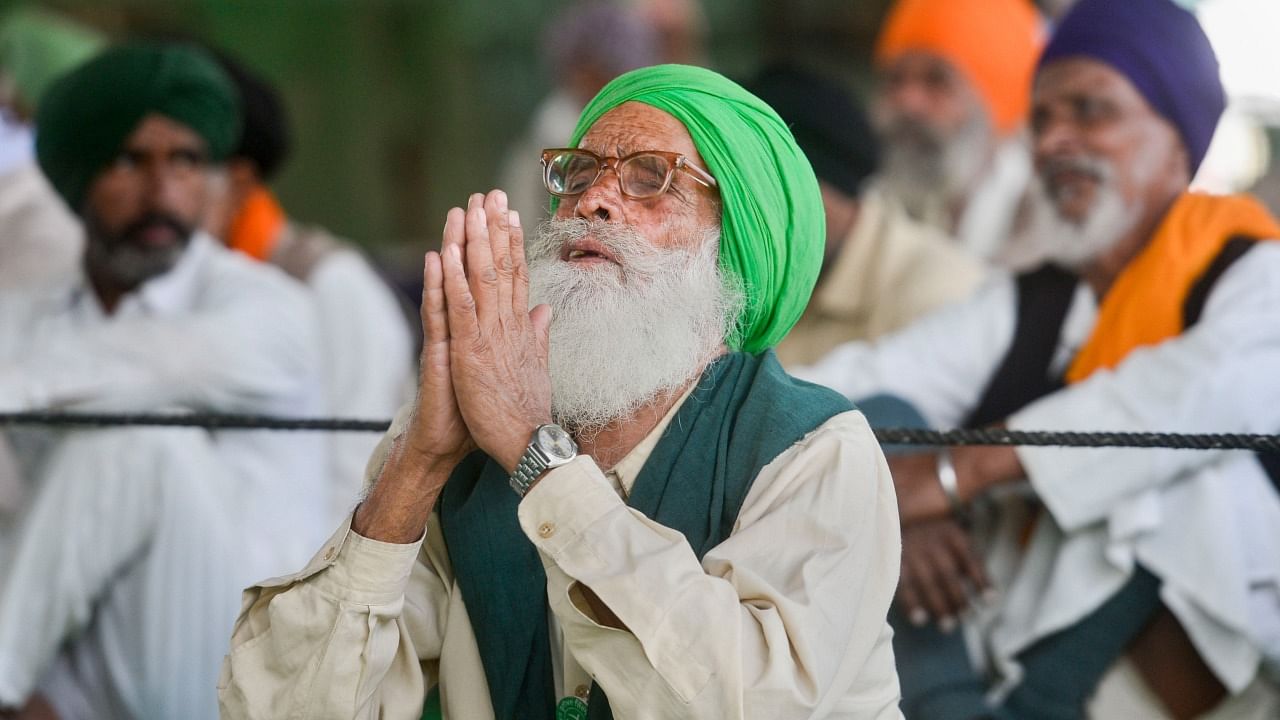 A farmer reacts after Prime Minister Narendra Modi announced the repealing of the three Central farm laws, at Singhu Border in New Delhi. Credit: PTI File Photo