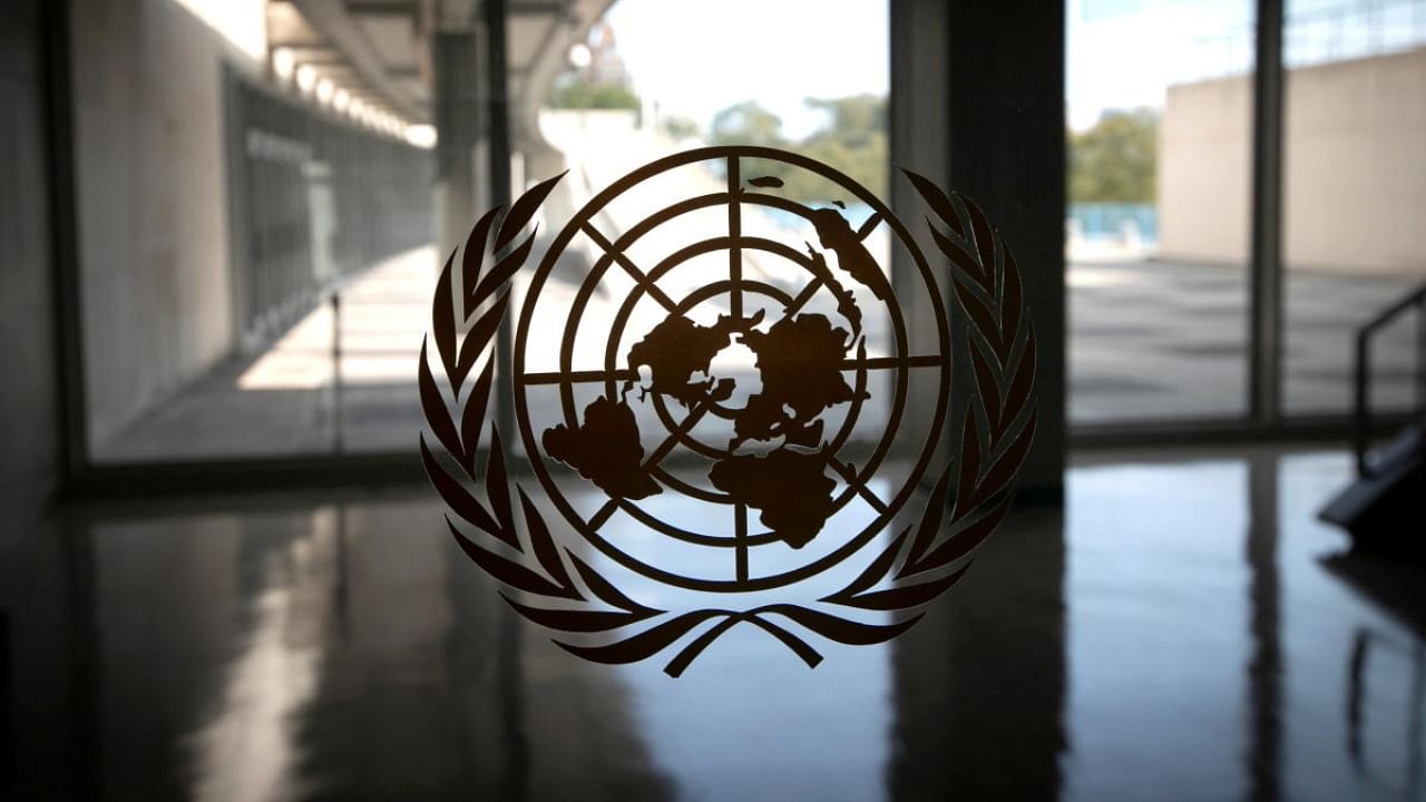 The United Nations logo is seen on a window in an empty hallway at United Nations headquarters. Credit: Reuters Photo
