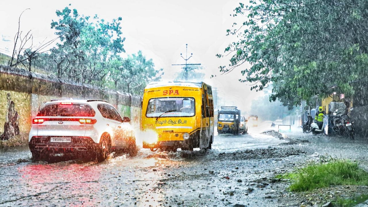 A school bus carrying children wades through a waterlogged road as schools have given sudden leave due to heavy rainfall, in Thoothukudi. Credit: PTI Photo