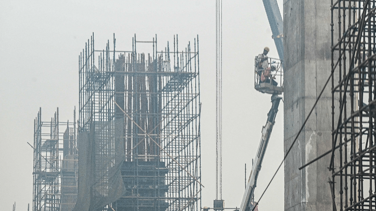 Labourers work at the construction site of the Delhi–Meerut Regional Rapid Transit System under heavy smoggy conditions in Ghaziabad. Credit: AFP Photo