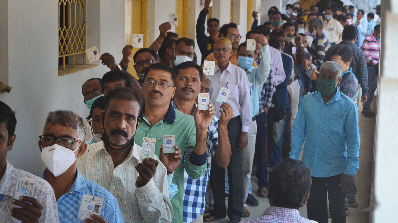 Government employees chosen for election duty for civic polls wait in a queue to cast postal ballot, in Agartala. Credit: PTI Photo