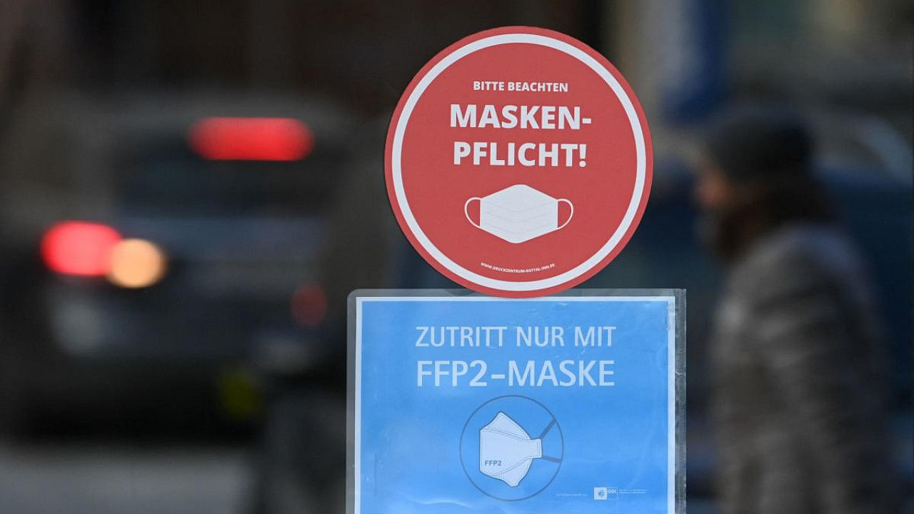 A sign for mandatory wearing of FFP2 face protection masks is seen at the entrance of a shop in the city of Eggenfelden, southern Germany. Credit: AFP Photo