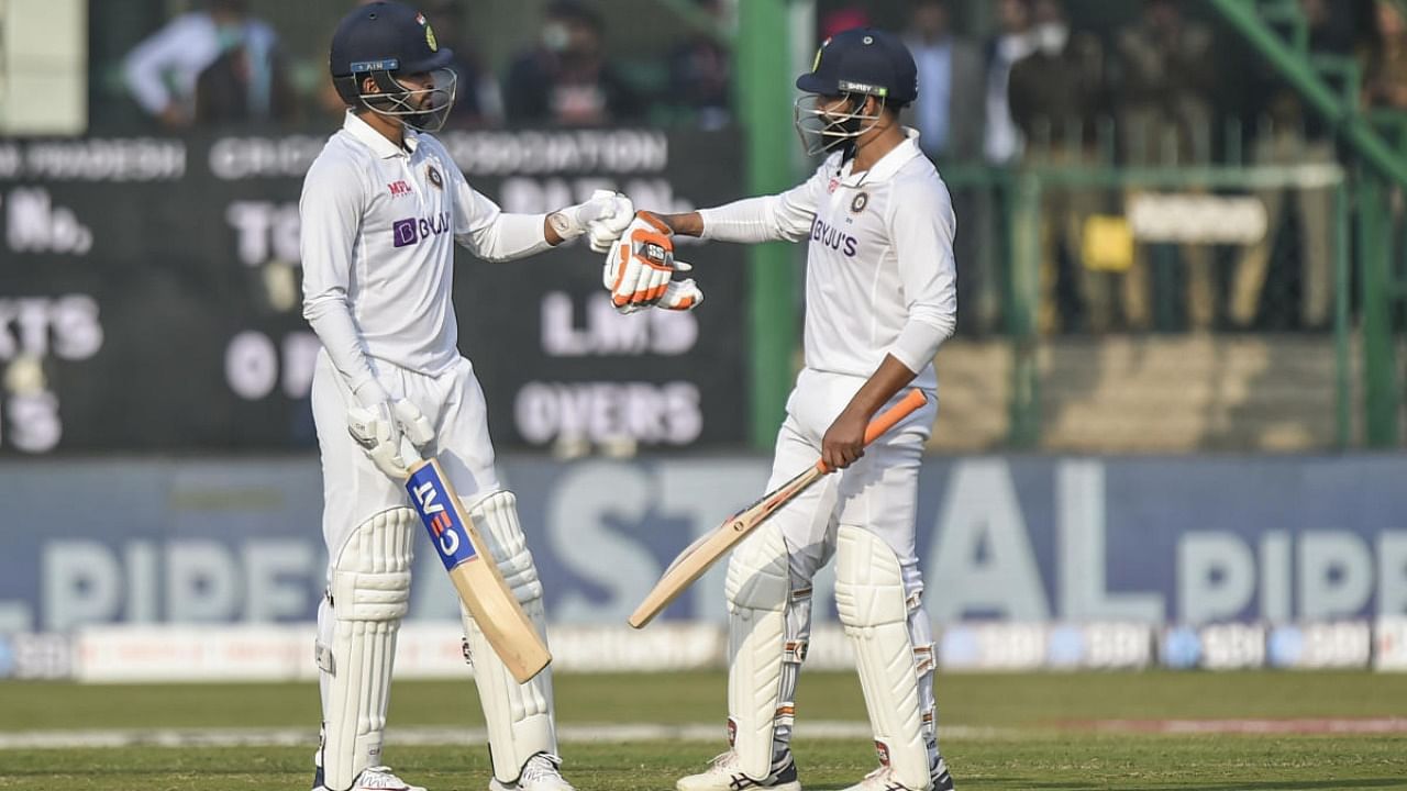 Indian player Shreyas Iyer celebrates with Ravindra Jadeja after scoring a half-century during day one of the 1st cricket test match between India and New Zealand, at Green Park stadium in Kanpur. Credit: PTI Photo