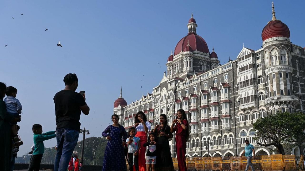 Tourists visit near the Taj Mahal Palace hotel, one of the sites of the 2008 terrorist attacks, in Mumbai. Credit: AFP Photo