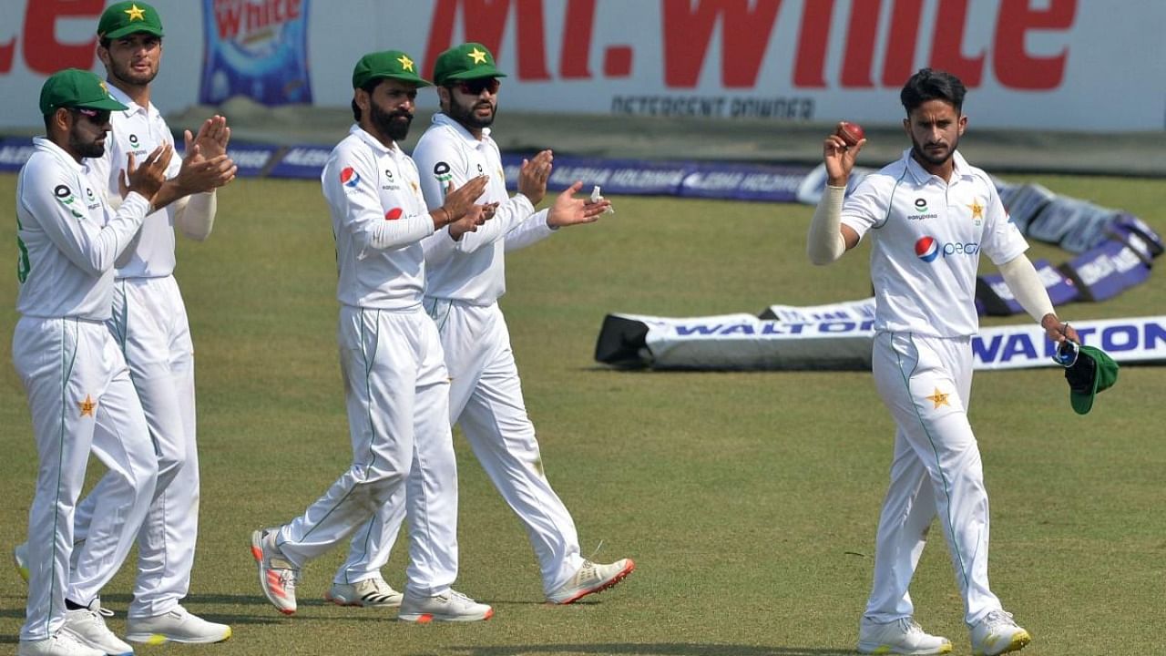 Pakistan's Hasan Ali (R) shows the ball as he celebrates along with his teammates after taking five wickets on the second day of the first Test cricket match between Bangladesh and Pakistan at the Zahur Ahmed Chowdhury Stadium in Chittagong. Credit: AFP Photo