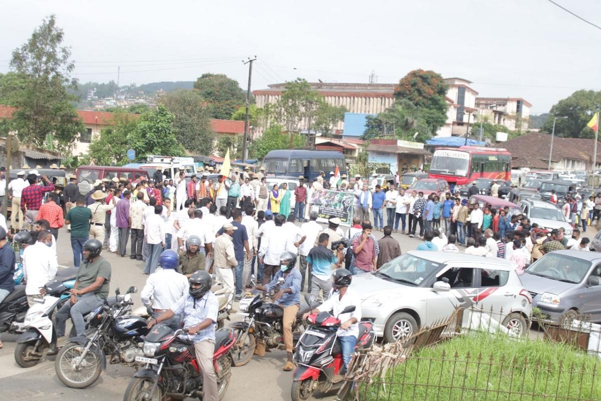 Farmers arrive in vehicles to stage a protest at General Thimayya Circle in Madikeri.
