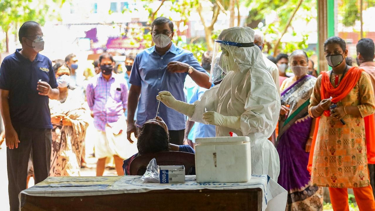 Health workers take swab samples for Covid-19 testing as coronavirus cases surge in Kozhikode. Credit: PTI File Photo