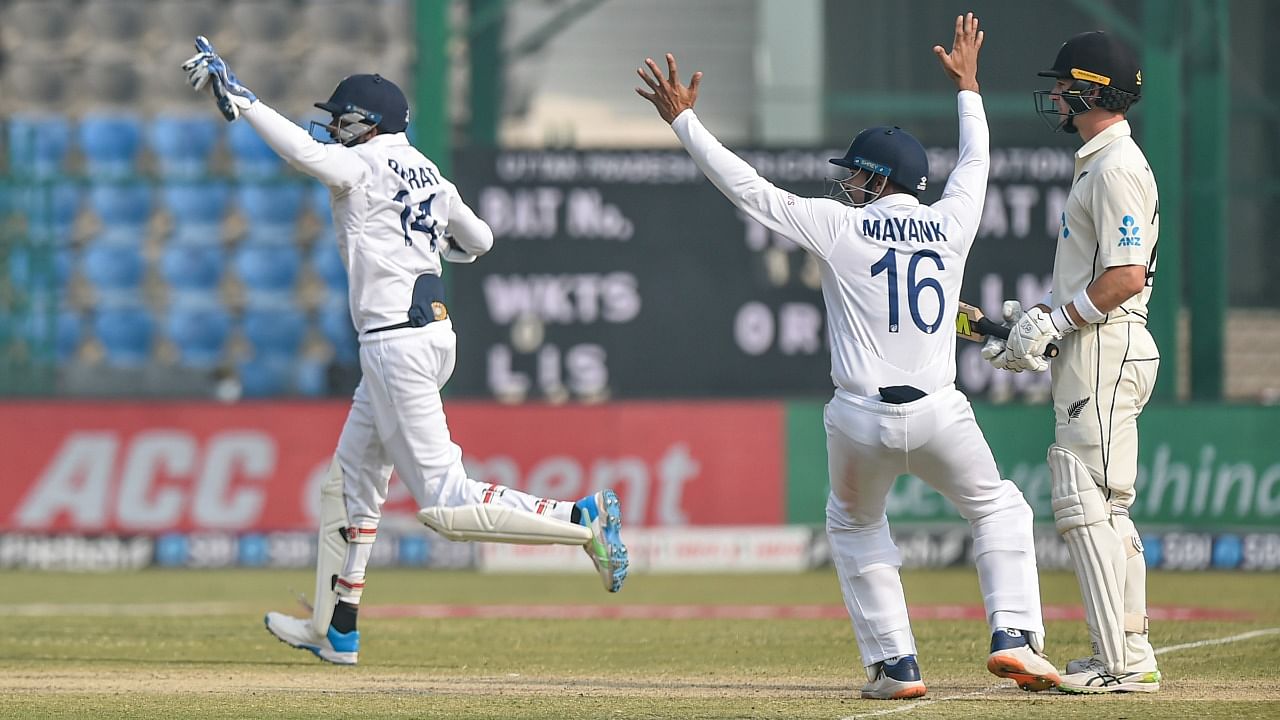 Indian players celebrate the dismissal of New Zealand batsman Will Young during third day of the first Test cricket match between India and New Zealand, at Green Park stadium in Kanpur, Saturday, November 27, 2021. Credit: PTI Photo