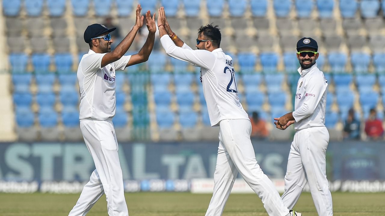 Axar Patel celebrates the dismissal of New Zealand batsman Tom Latham with teammates during third day of the first Test cricket match between India and New Zealand, at Green Park stadium in Kanpur. Credit: PTI Photo