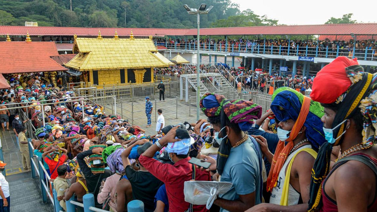 Devotees stand in a queue to visit the Sabarimala Temple in Pathanamthitta district. Credit: PTI Photo