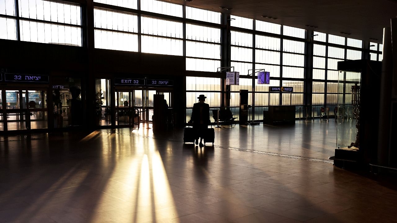 A passenger arrives to a terminal at Ben Gurion international airport before Israel bans international flights, taking effect from Monday,