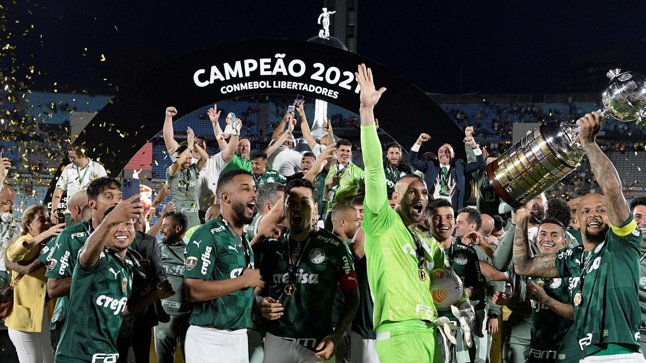 Palmeiras players celebrate with the trophy of the Copa Libertadores football tournament