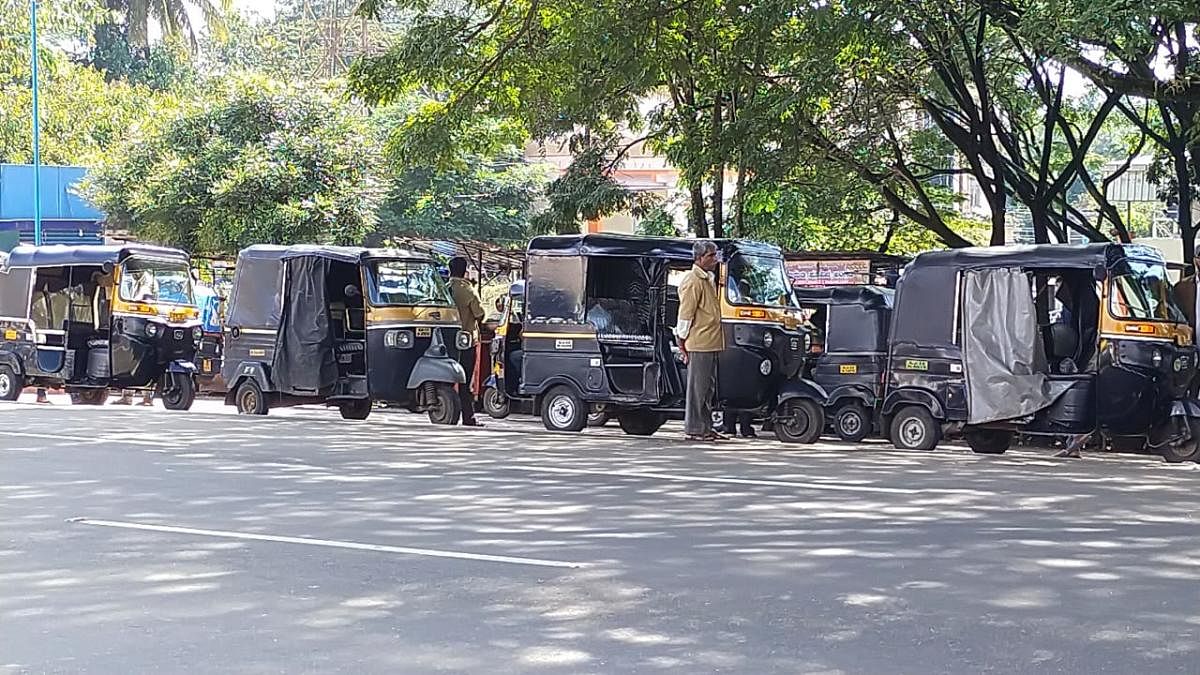 Autorickshaws wait in a stand for customers in Kushalnagar.