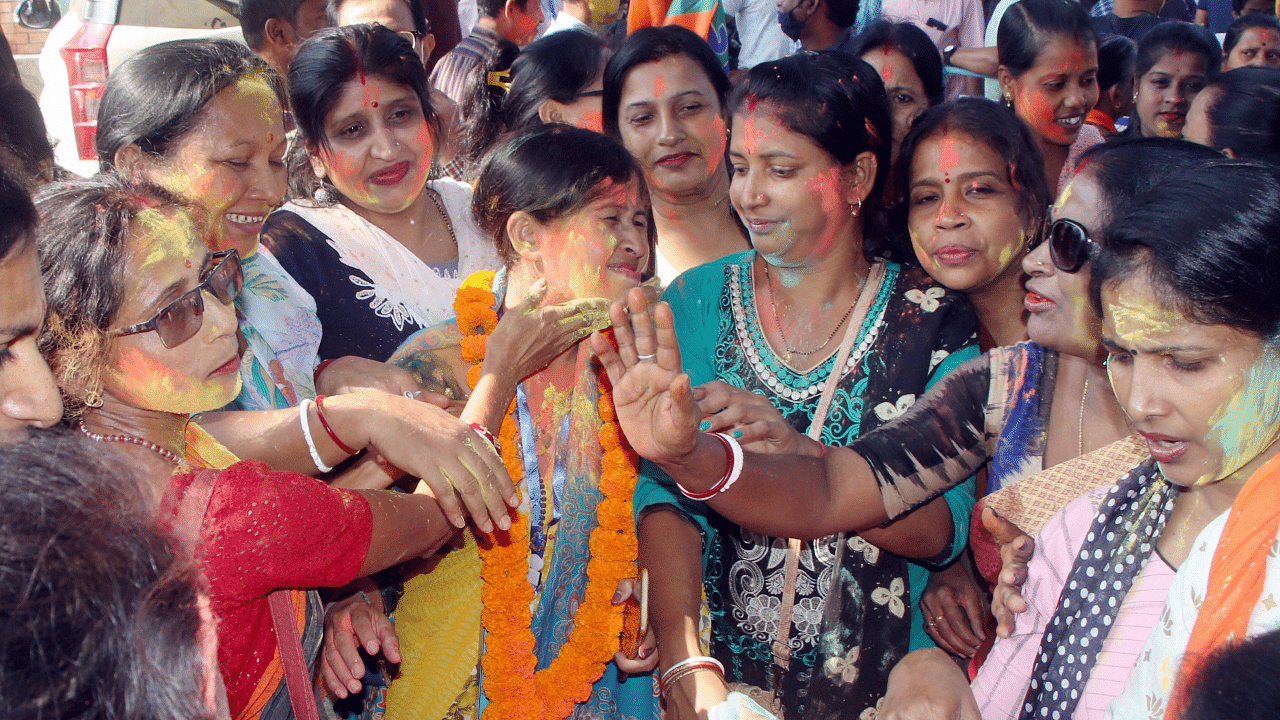 Supporters of Bharatiya Janata Party dance as they celebrate the party's lead during counting for the Tripura Municipal Corporation elections. Credit: PTI Photo