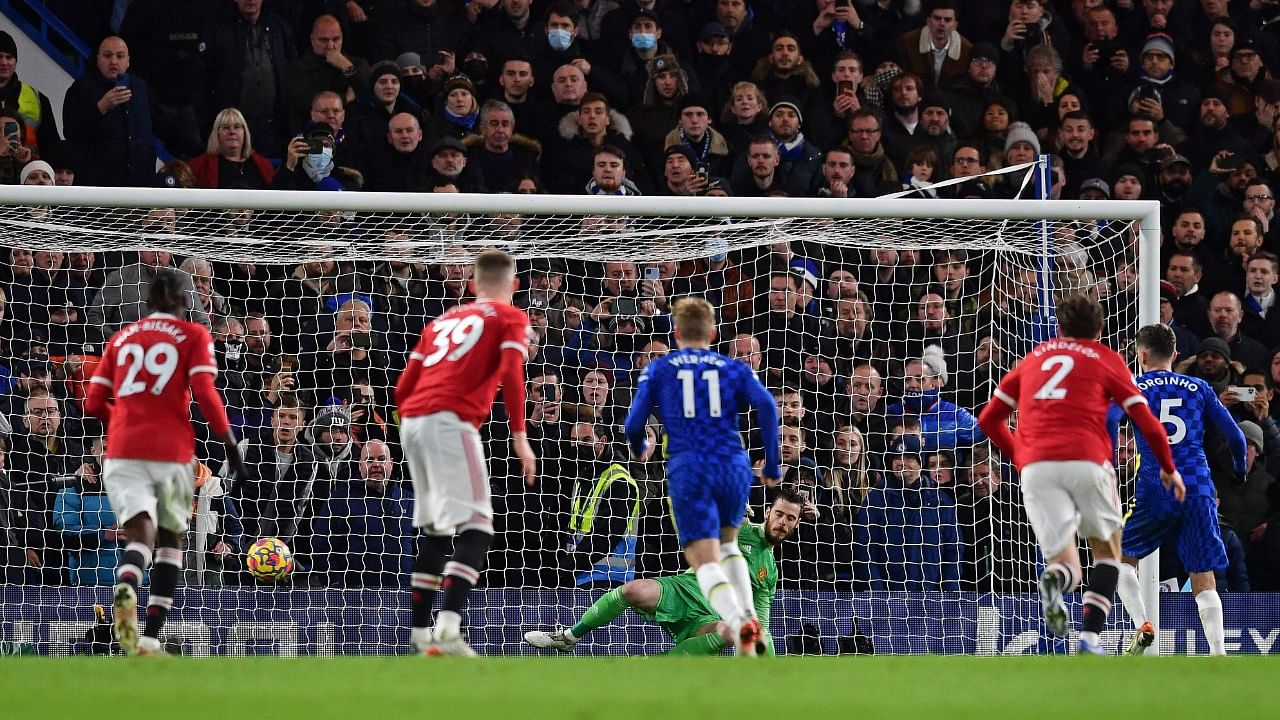 Chelsea's Italian midfielder Jorginho (R) shoots from the penalty spot to score the equalising goal. Credit: AFP Photo