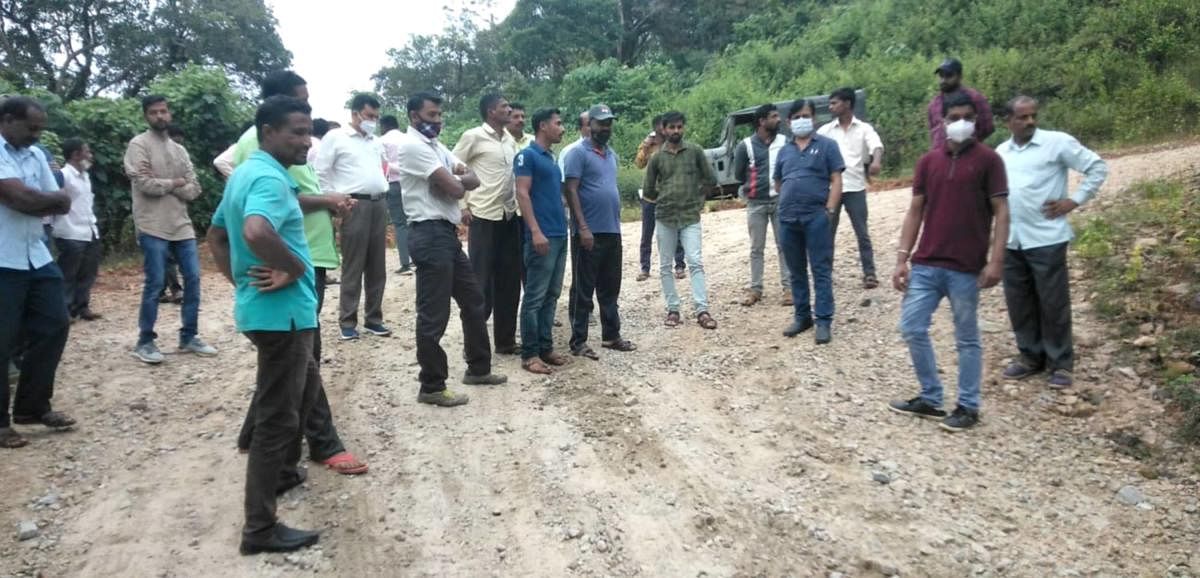 State Highway Development Authority Superintending Engineer Purushottam S Heggade inspects the road works in Somwarpet.