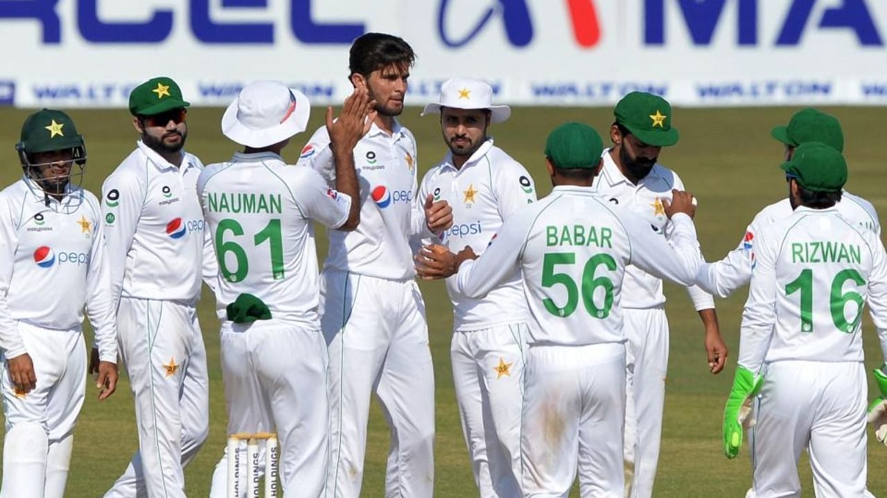 Pakistan's Shaheen Shah Afridi (C) celebrates with his teammates after taking five wickets on the fourth day of the first Test cricket match between Bangladesh and Pakistan at the Zahur Ahmed Chowdhury Stadium in Chittagong on November 29, 2021. Credit: AFP Photo