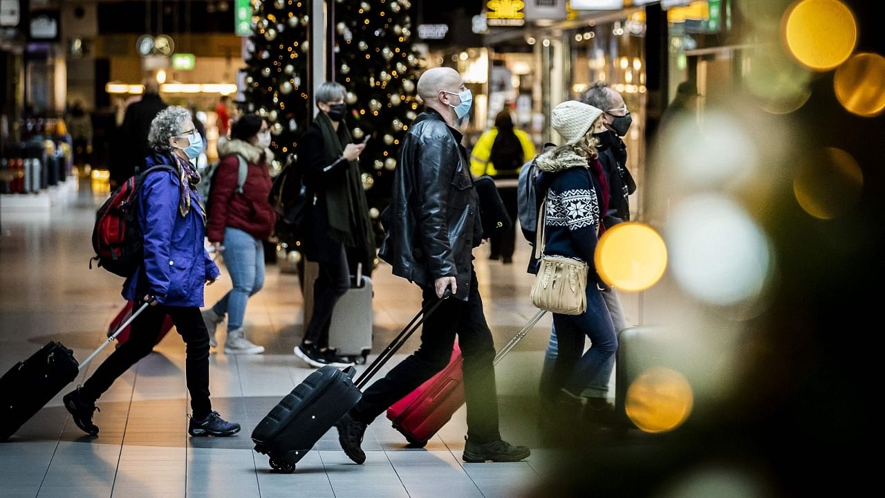 Travellers walk at the Schiphol Airport in Amsterdam. Credit: AFP Photo