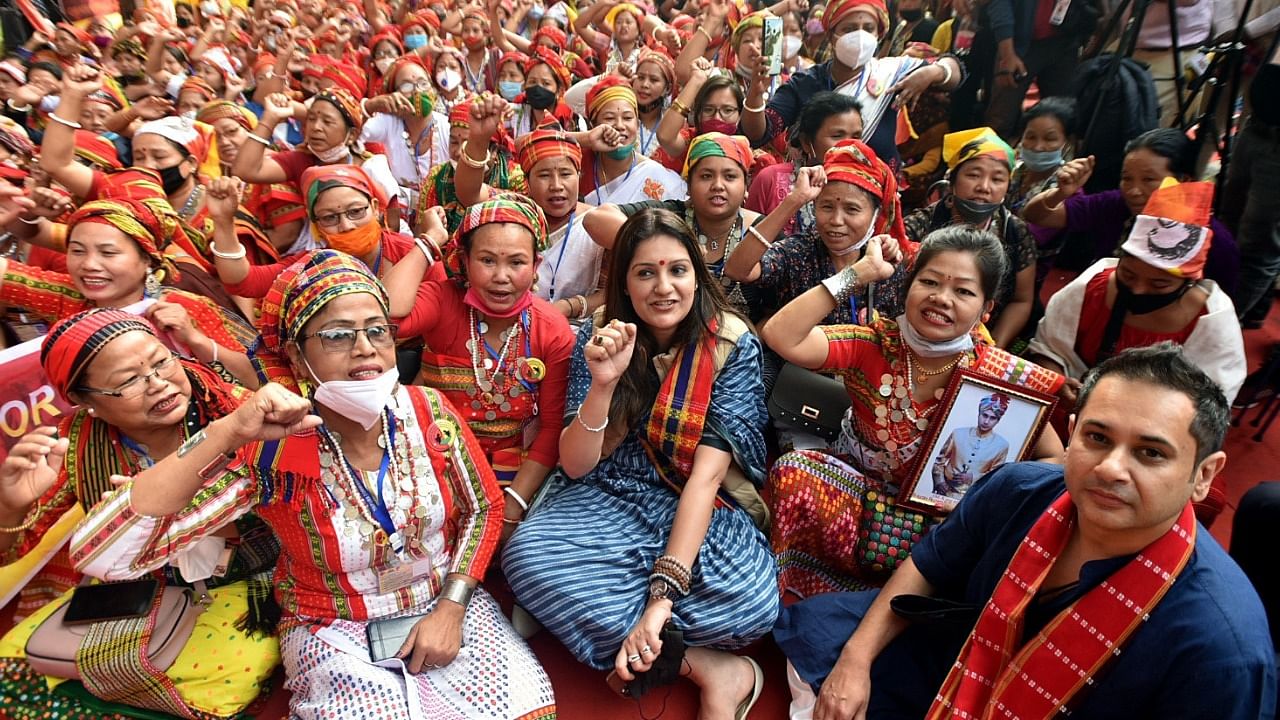 Suspended Shiv Sena Rajya Sabha MP Priyanka Chaturvedi with tribals during a protest for a separate state in Tripura in New Delhi. Credit: IANS Photo