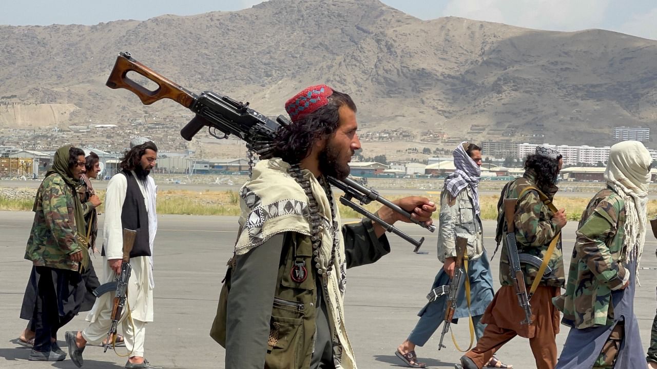 Taliban forces patrol at a runway. Credit: Reuters Photo